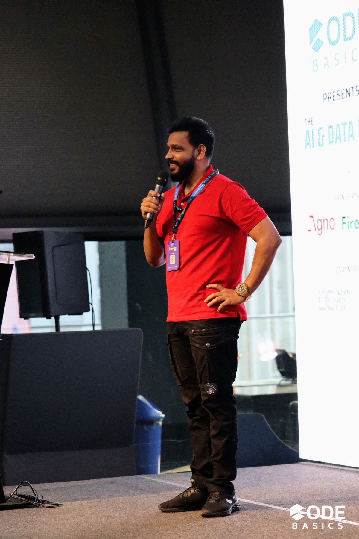 Kalyan Prasad speaking on stage at a technical conference.
